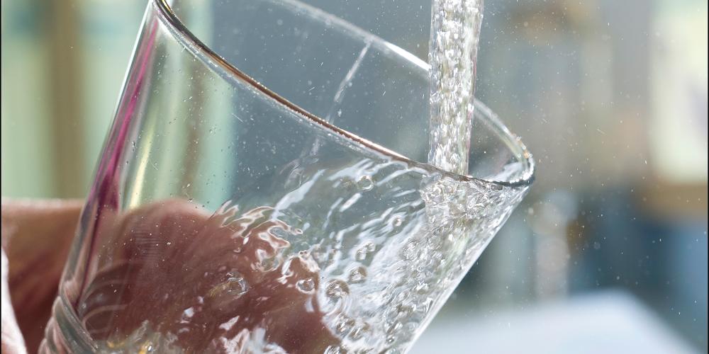 Glas water onder kraan